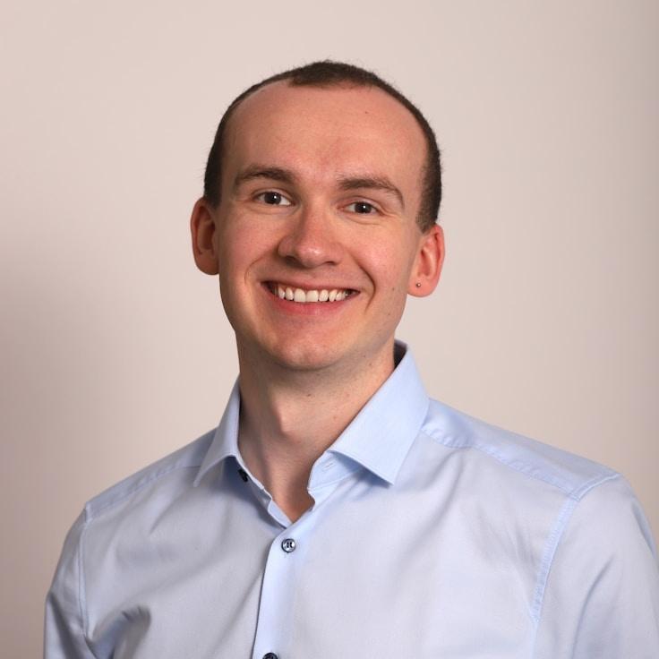 Ari Kapoor, Lead Design Curator at Whispering Forest Path, reviewing corporate floral arrangements